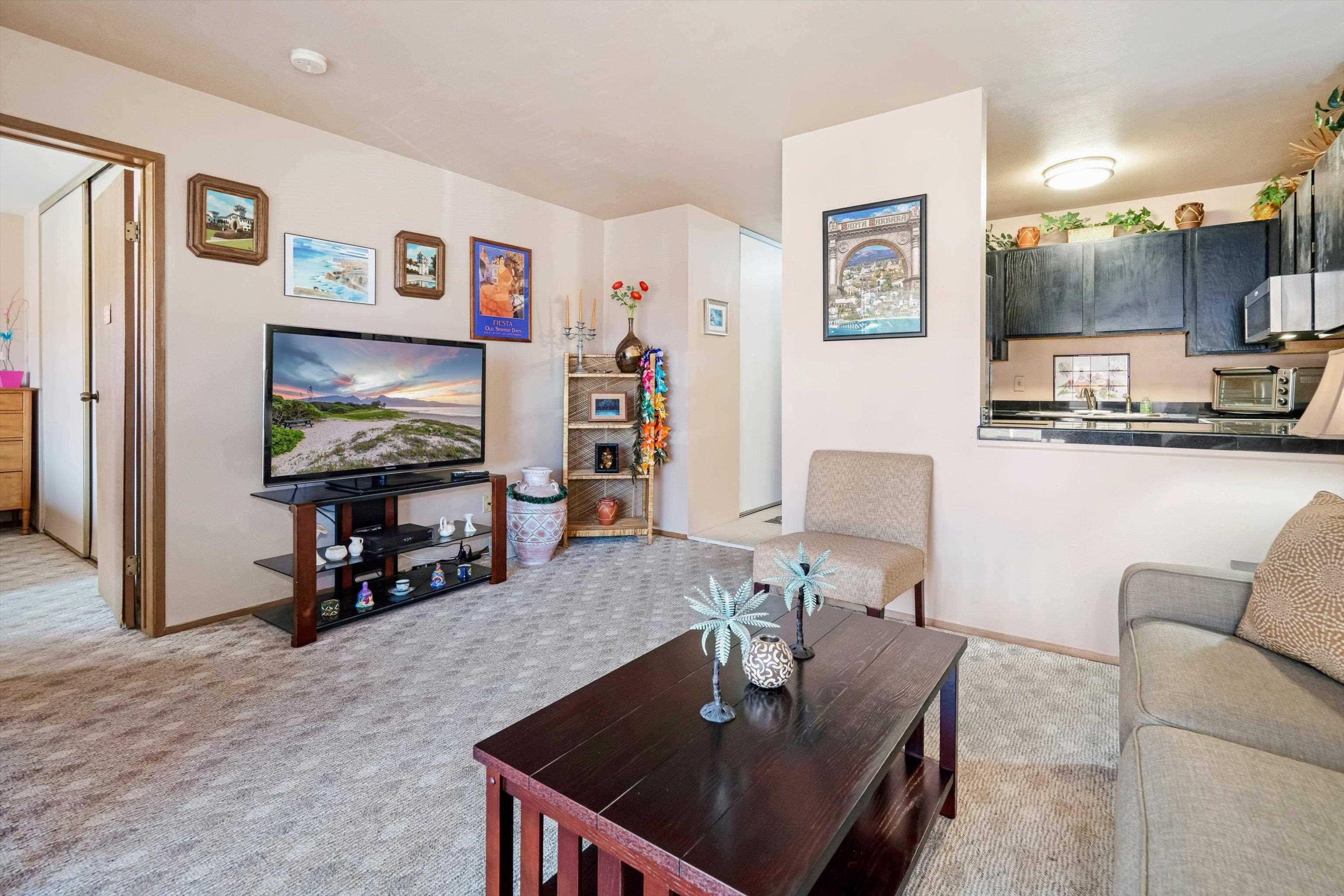 3740 Lower Honoapiilani Road, Unit C102 Lahaina, HI 96761 - Photo 4 of 50 a living room with furniture and a flat screen tv