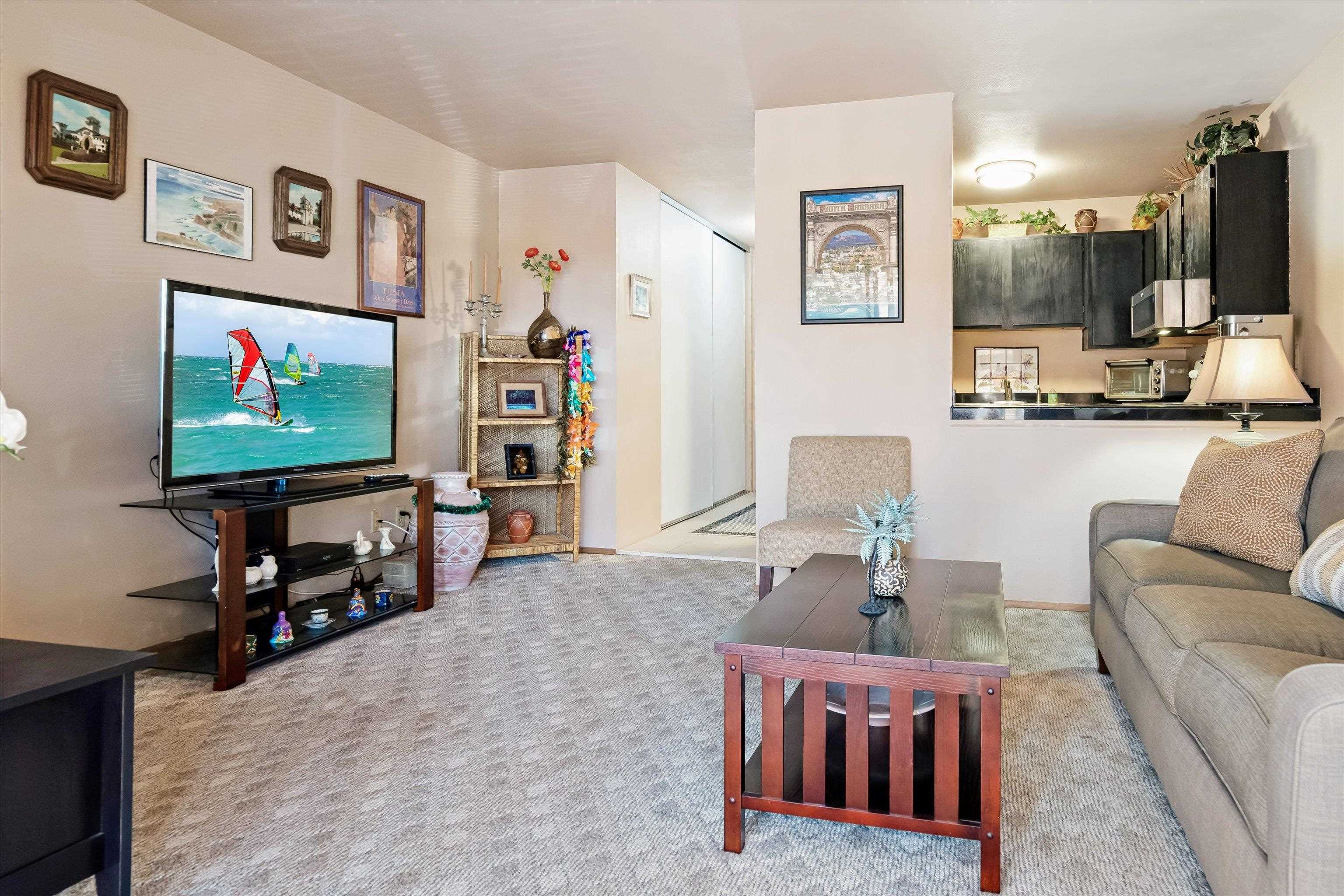 3740 Lower Honoapiilani Road, Unit C102 Lahaina, HI 96761 - Photo 5 of 50 a living room with furniture and a flat screen tv