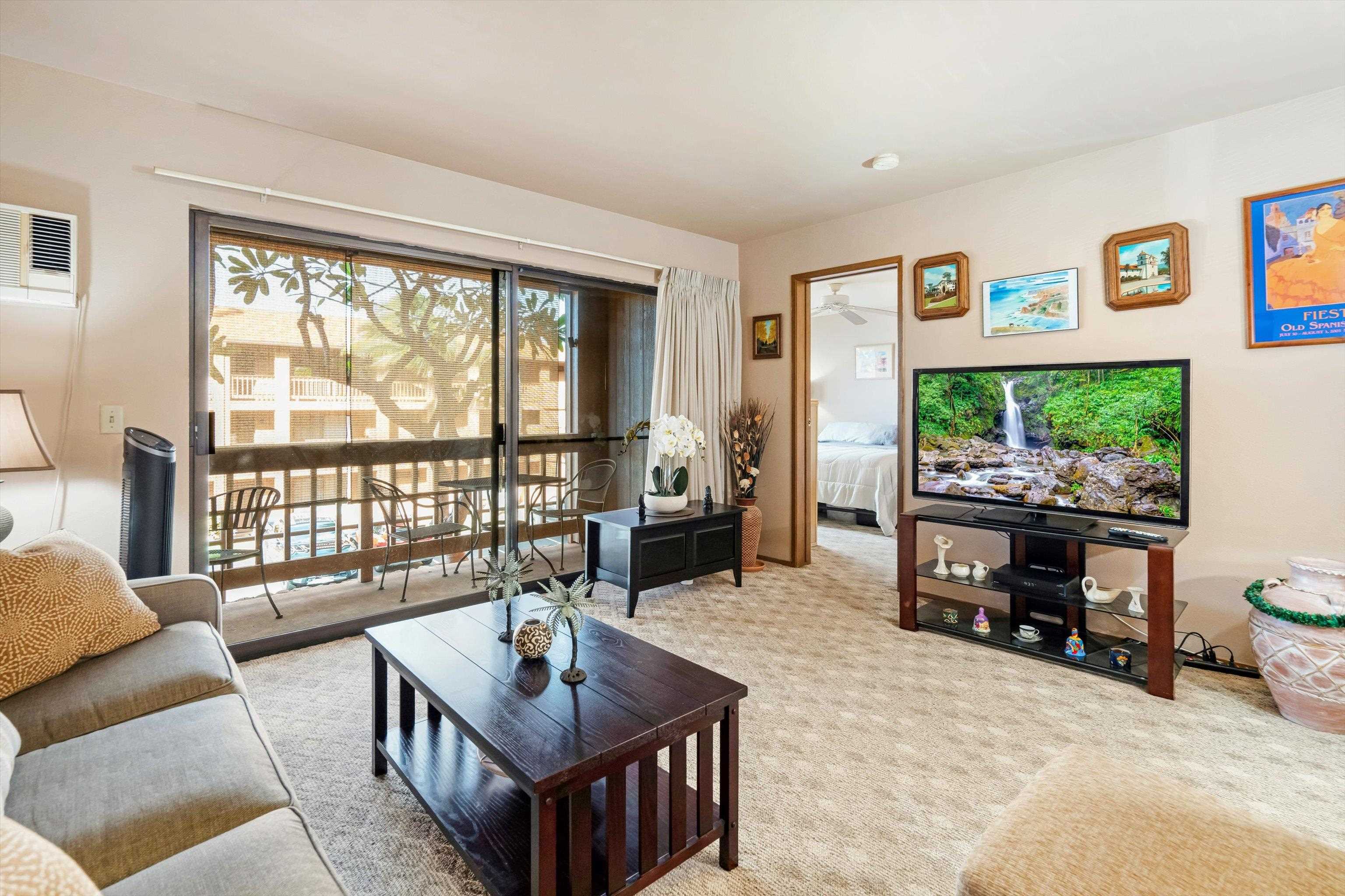 3740 Lower Honoapiilani Road, Unit C102 Lahaina, HI 96761 - Photo 9 of 50 a living room with furniture and a flat screen tv
