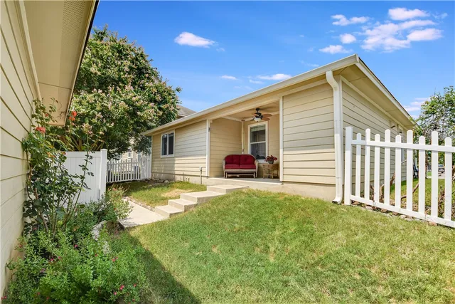 a view of a house with backyard and sitting area