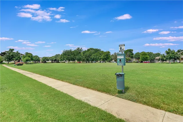 a view of a garden with a house