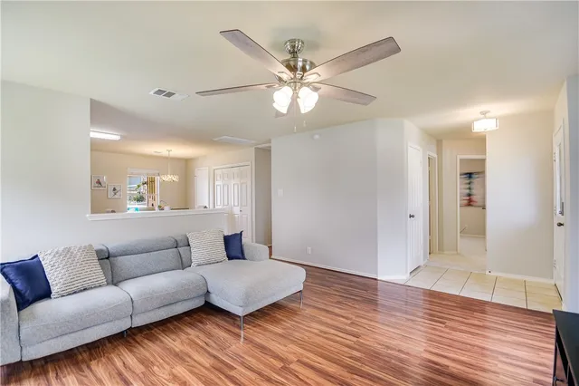 a living room with furniture and a wooden floor