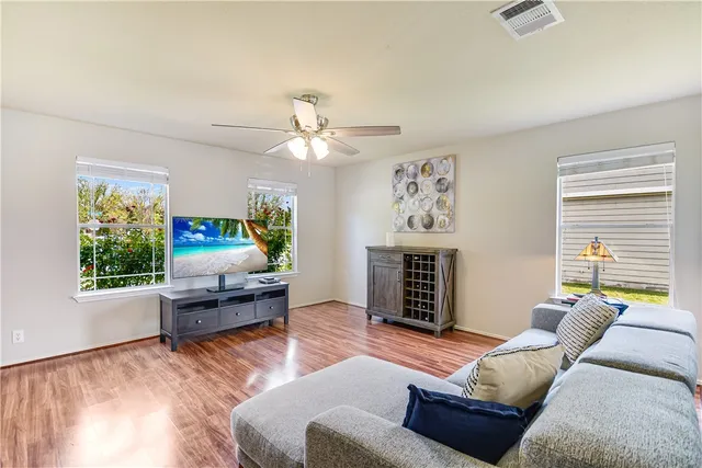a living room with furniture a fireplace and a window