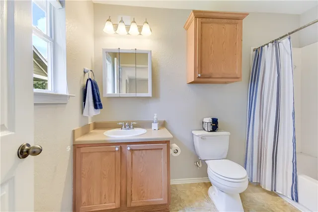 a bathroom with a toilet sink and mirror