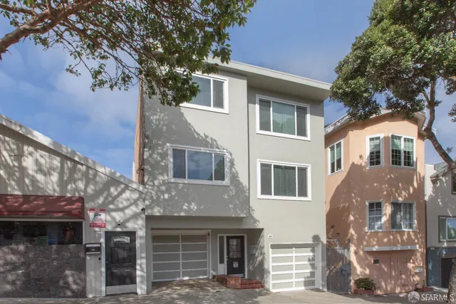 a front view of a building with a tree