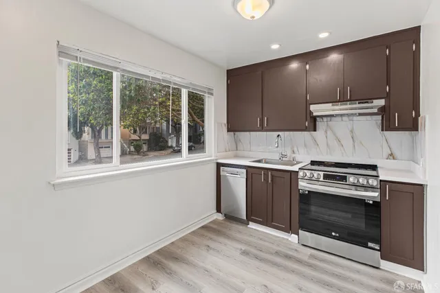 a kitchen with a stove a sink and a microwave