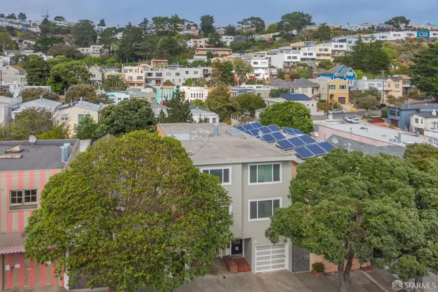 an aerial view of residential houses with outdoor space
