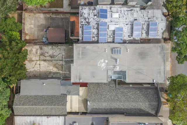 an aerial view of a house with a yard and a fountain