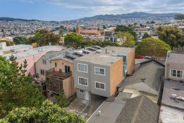 an aerial view of a house with a yard
