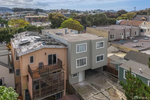 a view of a house with a tree in the background