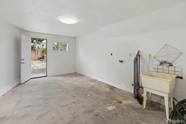 an empty room with a fireplace and window