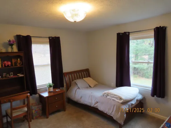 a living room with furniture a window and a flat screen tv