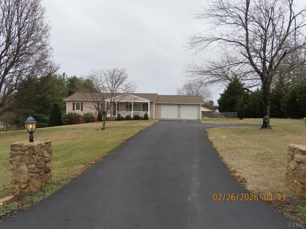 a front view of house with yard and green space