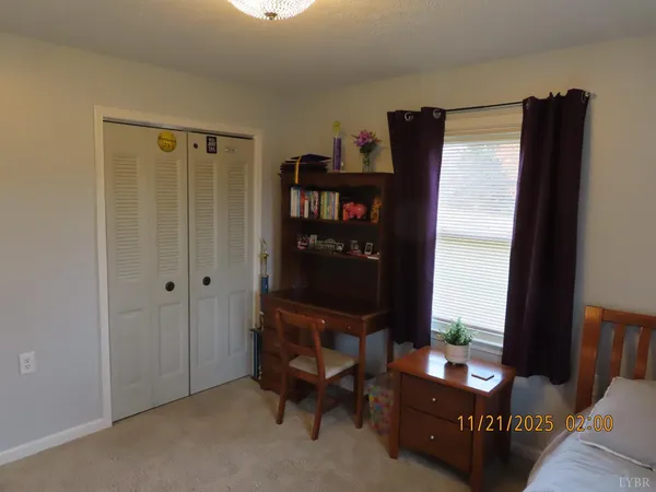 a room with furniture a bookshelf and a window