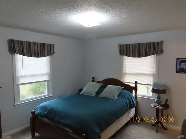 a bedroom with a bed and a television