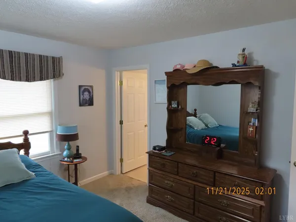 a bed sitting in a bedroom next to a window