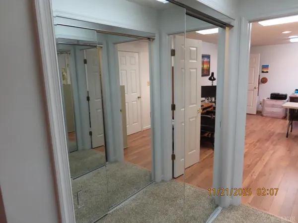 a view of a workspace with furniture and a workspace