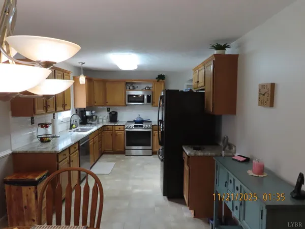 a kitchen with a sink a stove cabinets and a kitchen island
