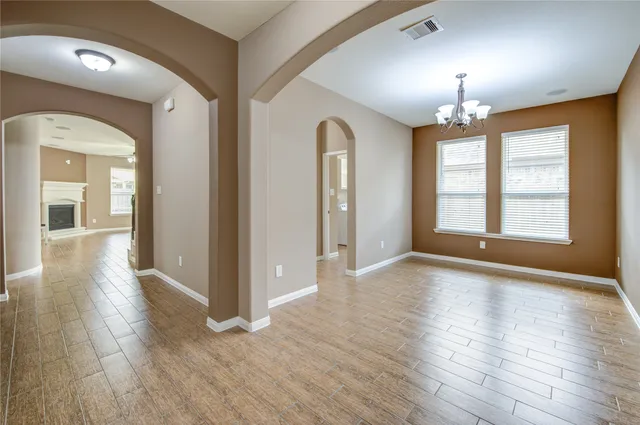 a view of livingroom with chandelier and wooden floor