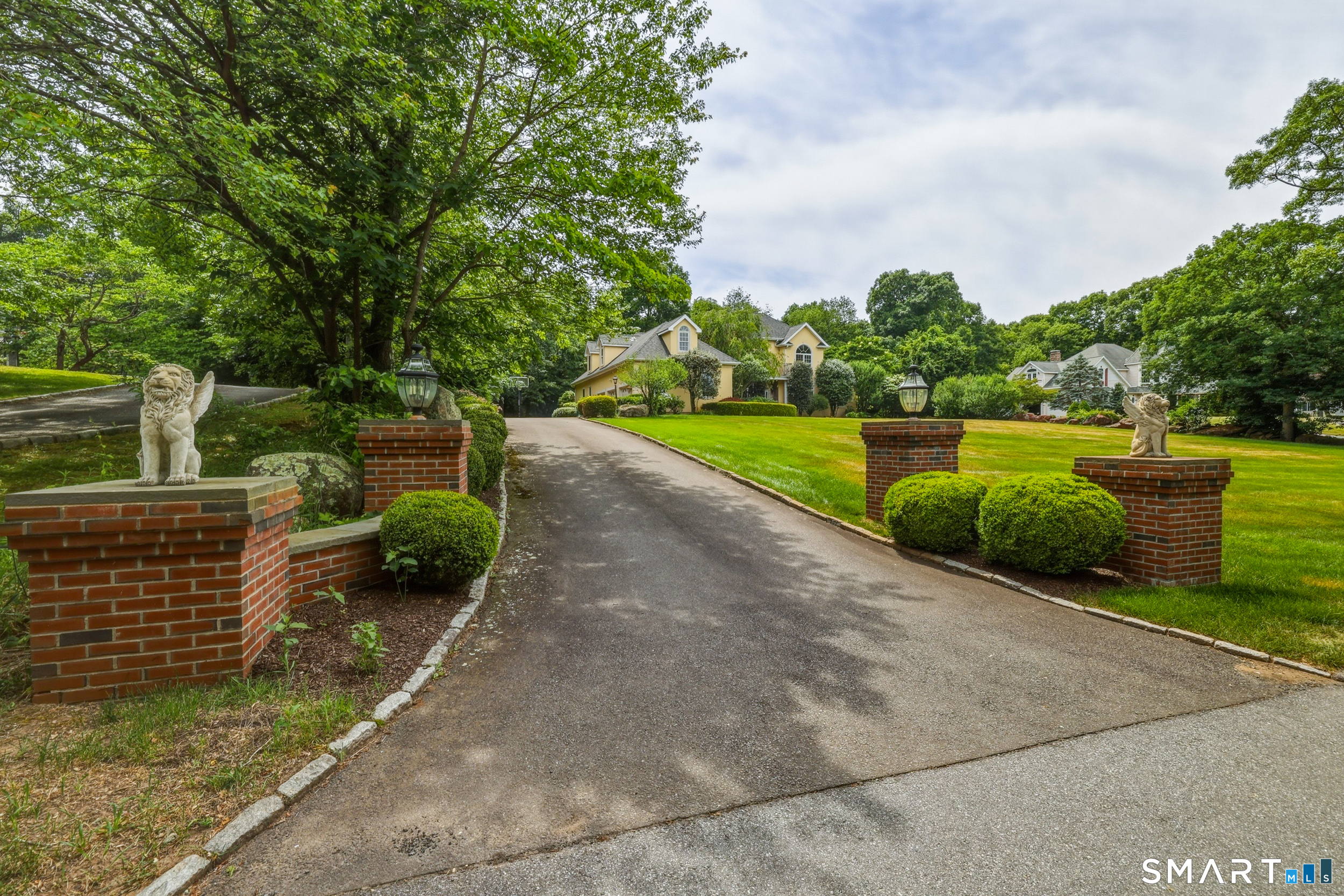 122 Lower Road Guilford, CT 06437 - Photo 32 of 39 An elegant long driveway approach is flanked by classic brick pillars, creating a stately and welcoming arrival that enhances the home's curb appeal.
