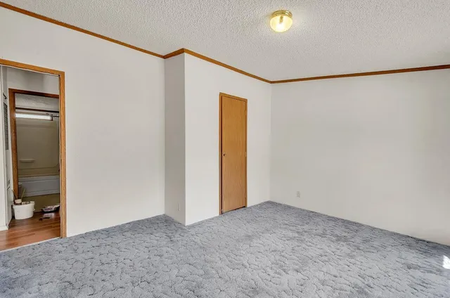 a bed room with furniture and large window