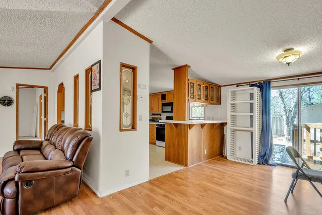 a kitchen with stainless steel appliances granite countertop a refrigerator and a stove top oven