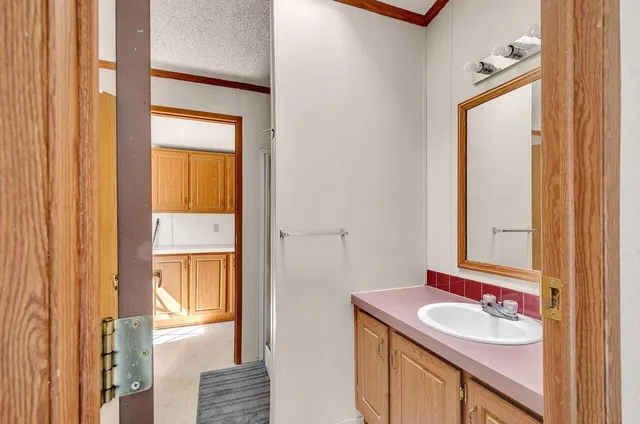 a view of hallway with cabinets