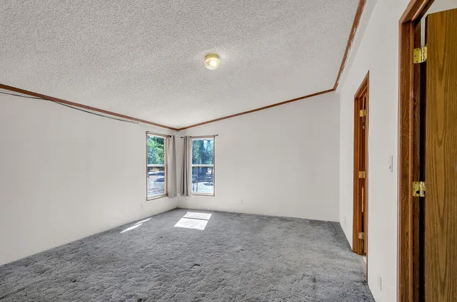a view of a kitchen with an empty space and a window