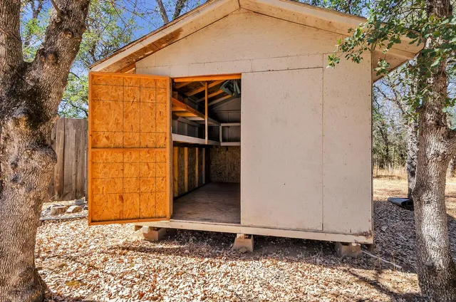 a view of empty room with wooden walls
