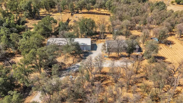 an aerial view of a house with a yard