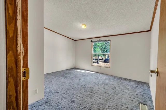 a bathroom with a granite countertop bathtub shower sink mirror vanity and toilet