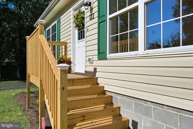 a view of a house with a door and stairs