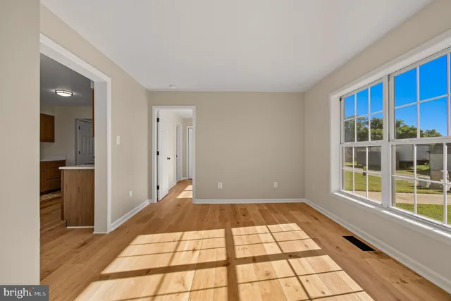 a view of a room with an empty room and window