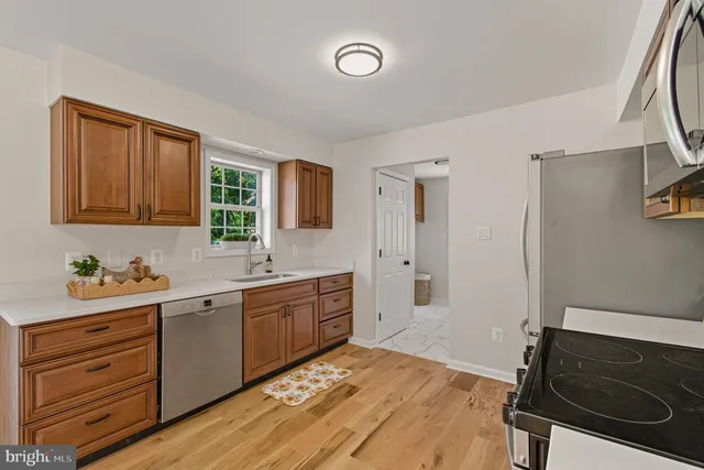 a kitchen with appliances cabinets and a window