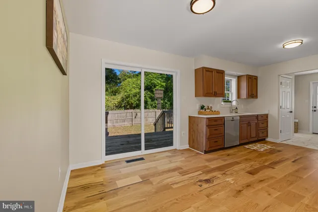 a view of a kitchen with wooden cabinet and a sink