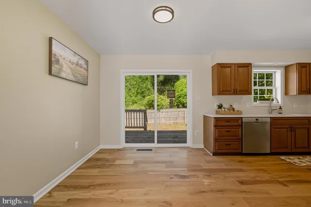 a view of a room with wooden floor and window