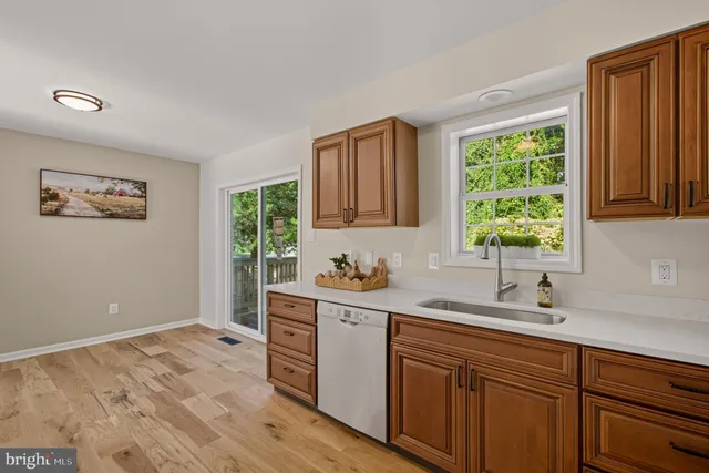 a kitchen with a sink and wooden cabinets
