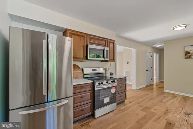 a kitchen with stainless steel appliances a refrigerator stove and microwave