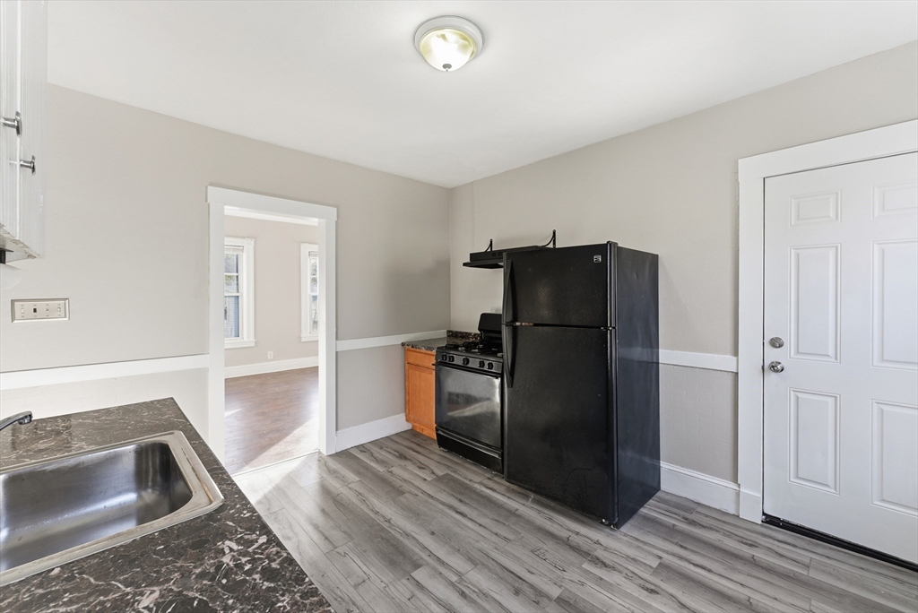 74-76 Maple Terrace West Springfield, MA 01089 - Photo 14 of 39 a kitchen with a refrigerator cabinet and a sink