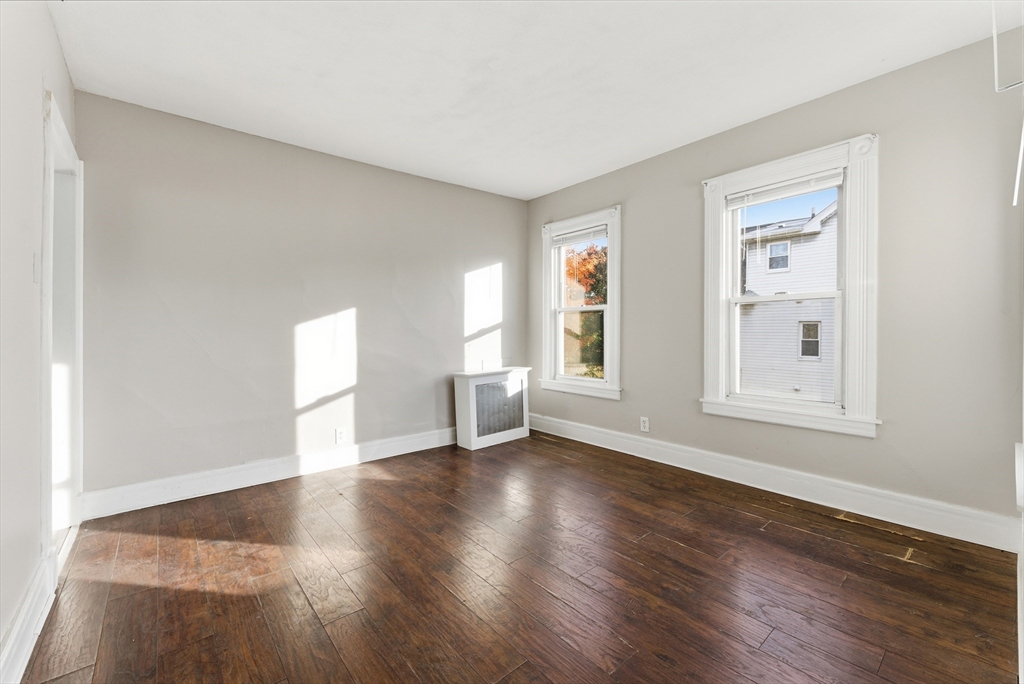 74-76 Maple Terrace West Springfield, MA 01089 - Photo 15 of 39 a view of an empty room with wooden floor and a window