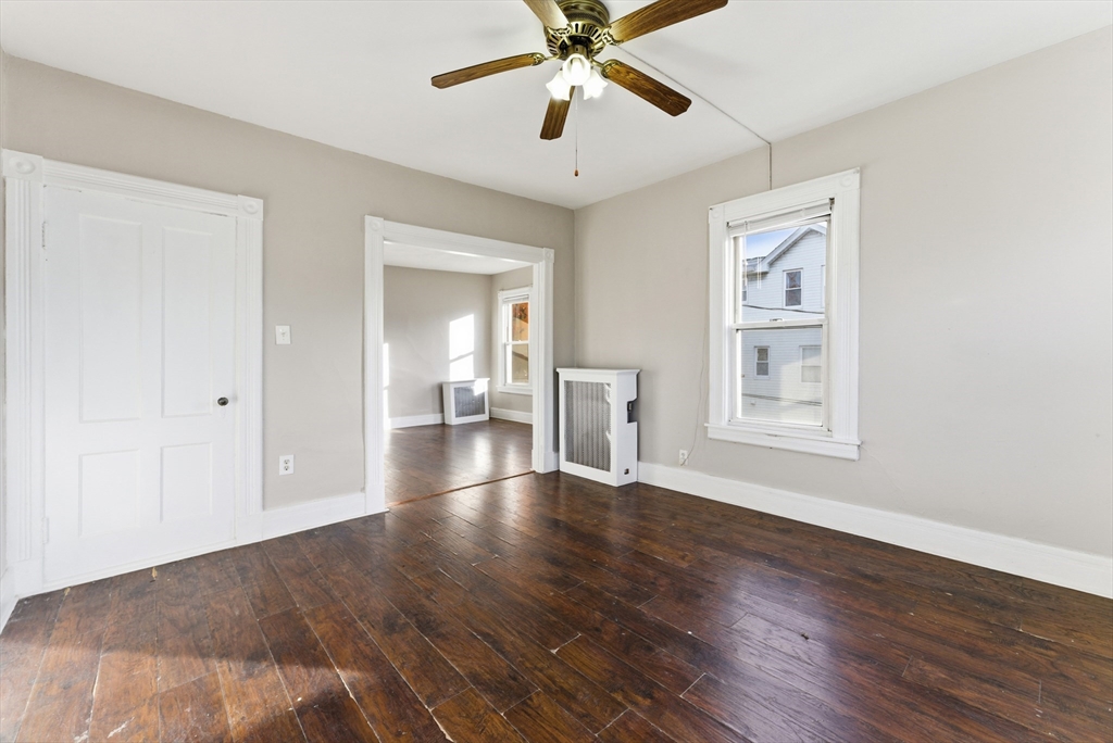 74-76 Maple Terrace West Springfield, MA 01089 - Photo 18 of 39 a view of an empty room with wooden floor and a window