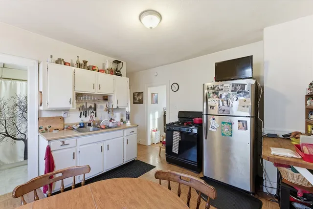 a kitchen with stainless steel appliances a stove refrigerator and a sink