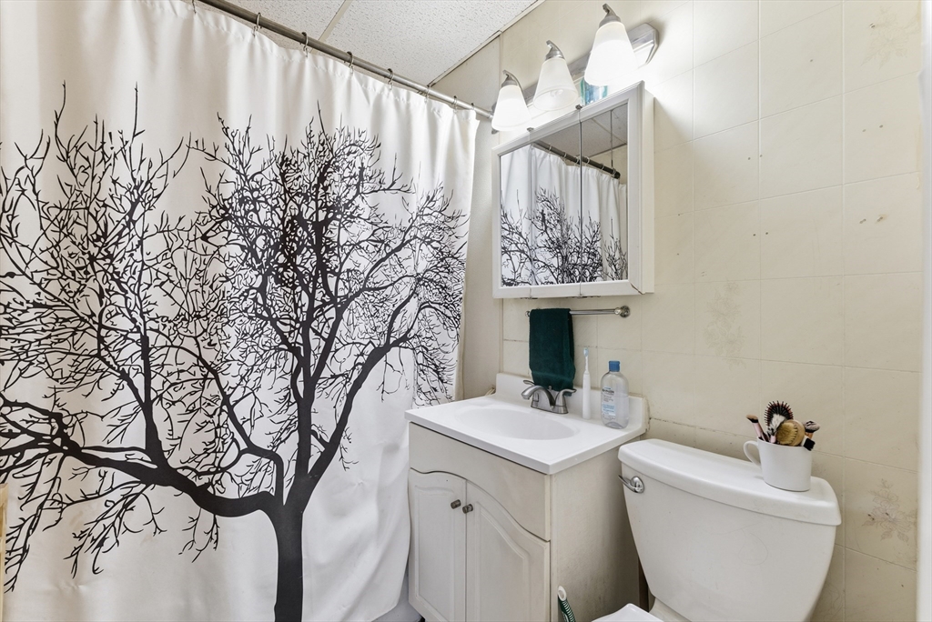 74-76 Maple Terrace West Springfield, MA 01089 - Photo 26 of 39 a bathroom with a toilet sink and mirror
