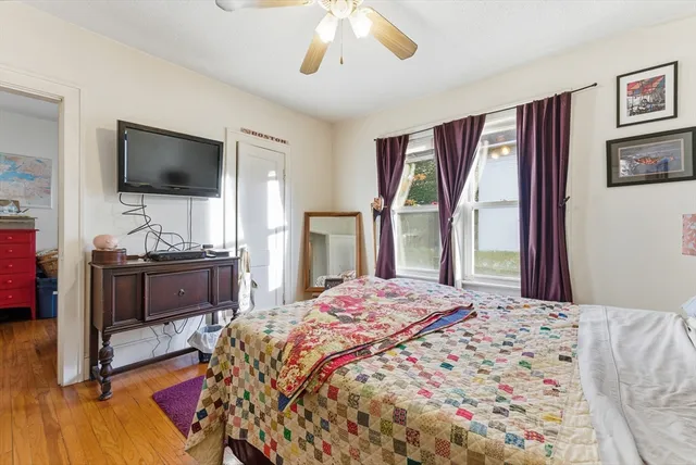 a bedroom with a bed and a flat screen tv