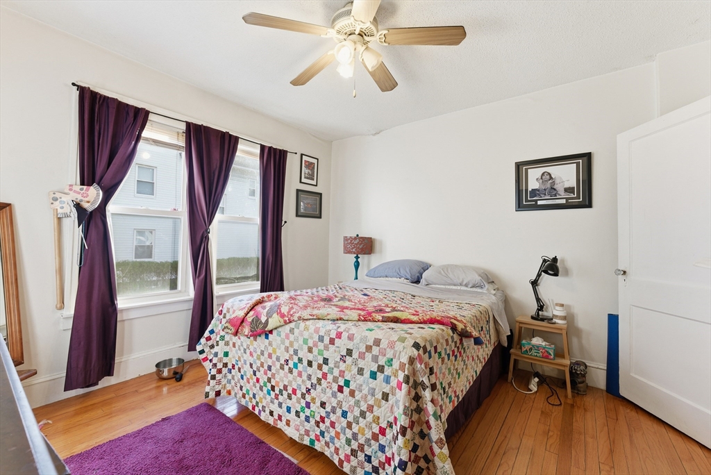 74-76 Maple Terrace West Springfield, MA 01089 - Photo 28 of 39 a bedroom with a bed and a chandelier