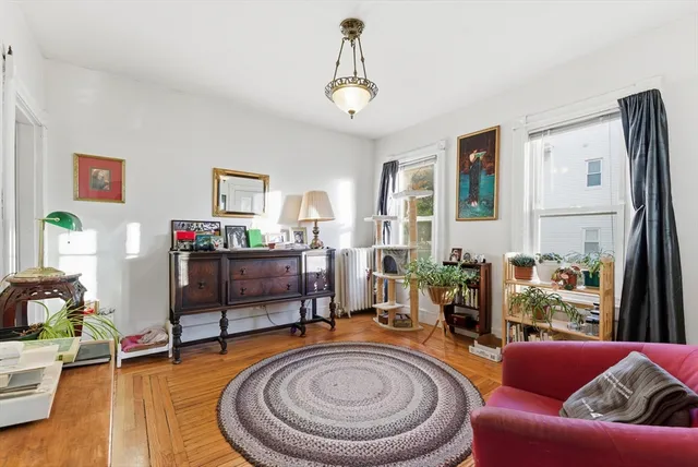 a living room with furniture and a chandelier