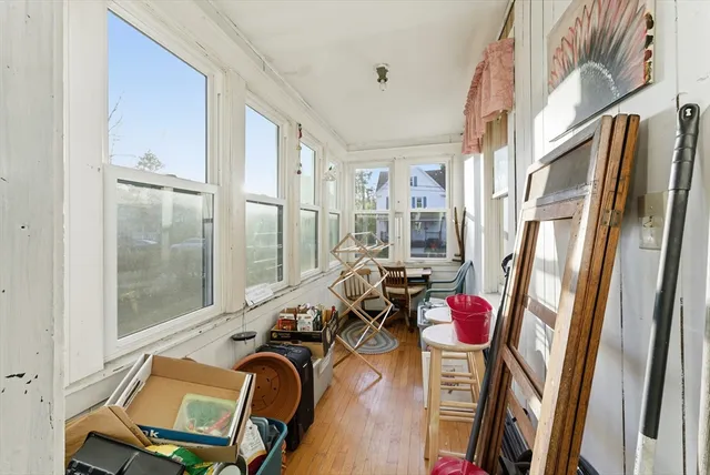 a view of a livingroom with furniture hardwood floor and a ceiling fan