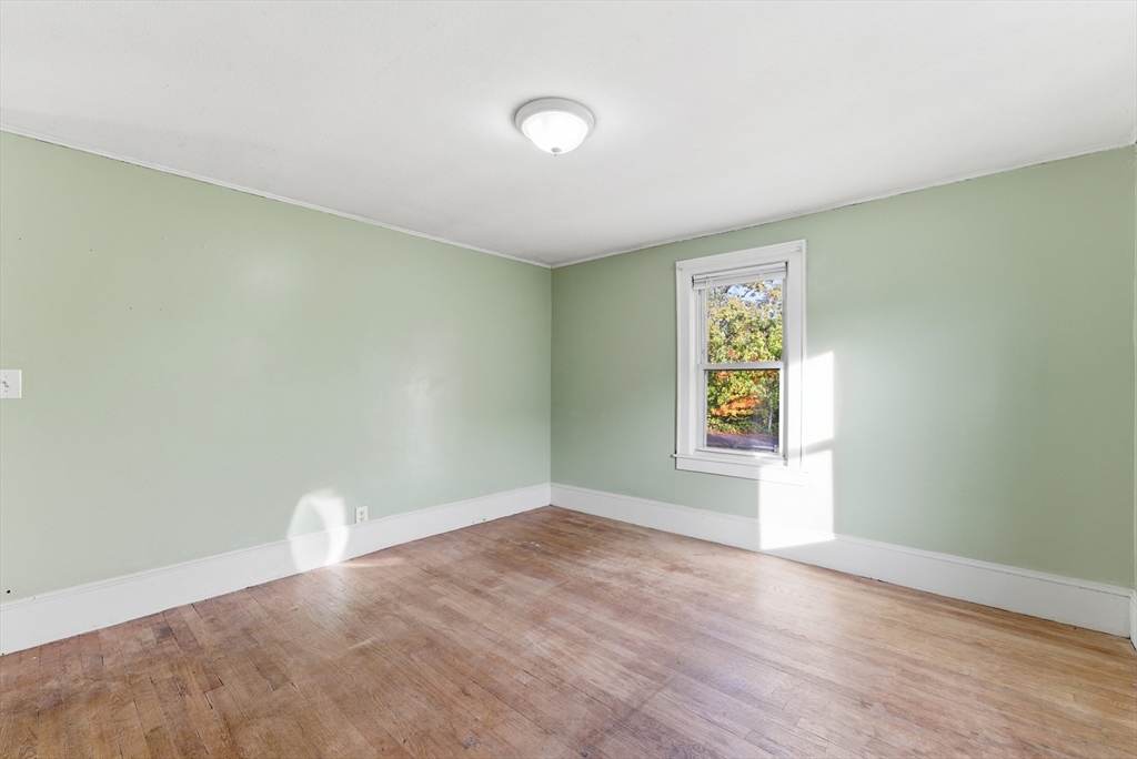 74-76 Maple Terrace West Springfield, MA 01089 - Photo 8 of 39 an empty room with wooden floor and windows