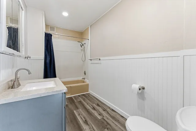 a bathroom with a sink toilet and shower