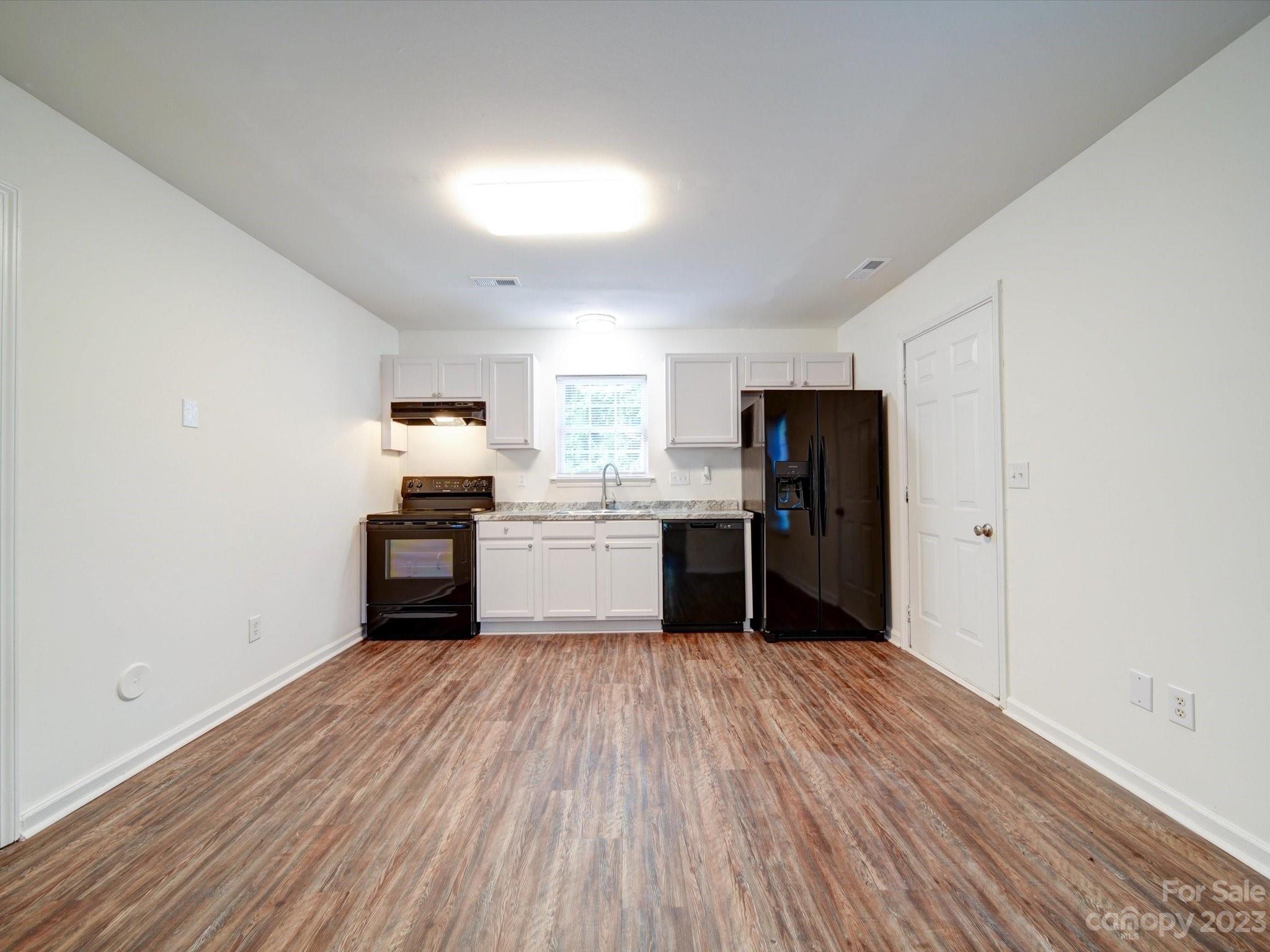 925 Key Street Charlotte, NC 28208 - Photo 14 of 41 a kitchen with stainless steel appliances granite countertop a refrigerator and a stove top oven